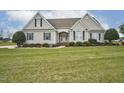 Beautiful house with an expansive green lawn and well-maintained landscaping at 1454 Spring Pond Rd, Nashville, NC 27856