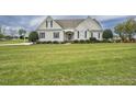 Inviting home with a lush green lawn and manicured landscaping at 1454 Spring Pond Rd, Nashville, NC 27856