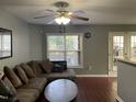 Comfortable living room with ample seating, a ceiling fan, and a view to the outside at 158 Randolph Dr, Clayton, NC 27520