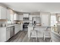 Bright, modern kitchen with white cabinets, stainless steel appliances, and granite countertops at 16 Saintsbury Dr, Fuquay Varina, NC 27526