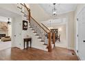 Elegant foyer with hardwood floors, staircase with iron spindles, and views to the dining room at 1602 Eagle Lodge Ln, Durham, NC 27703