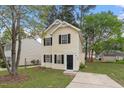 Quaint two-story home with tidy front yard landscaping offers great curb appeal and a welcoming feel at 1808 Elkpark Dr, Raleigh, NC 27610