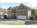 Beautiful two-story home with a brick facade, two-car garage, and well-maintained front yard at 1911 Firenza Dr, Apex, NC 27502