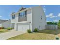 Corner view of a two-story home showing the two-car garage, yard and siding at 2065 Alderman Way, Creedmoor, NC 27522