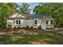Inviting single-story house features a cozy front porch and well-maintained landscaping at 2108 Canterbury Rd, Clayton, NC 27520