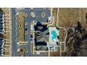 Overhead view of community amenities with a pool, clubhouse, and parking area, highlighting recreational features at 2137 Caen St, Raleigh, NC 27610