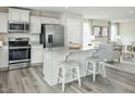 Modern kitchen with stainless steel appliances, granite countertops, and an island with seating at 227 South Breeze Way, Fuquay Varina, NC 27526