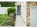 Inviting front entrance with well-maintained landscaping and a clean, modern walkway to the front door at 228 Adefield Ln, Holly Springs, NC 27540