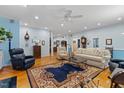 Open living room features hardwood floors, fireplace and multiple seating areas at 2456 Nealwood Ave, Graham, NC 27253