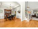 Inviting dining area with hardwood floors, elegant chandelier, and a classic hutch at 249 Mill Creek Dr, Clayton, NC 27527