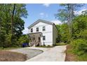 Bright home exterior with spacious driveway and lush surrounding trees at 2801 Dearborn Dr # A, Durham, NC 27704