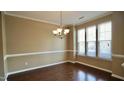 Inviting dining area with chandelier lighting and large windows at 2945 Casona Way, Raleigh, NC 27616