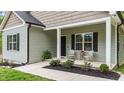 Inviting front porch with seating and stylish details for a welcoming entrance at 318 Natchez Trace, Fuquay Varina, NC 27526