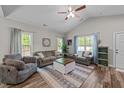 Bright and airy living room featuring vaulted ceilings, modern furniture, and large windows at 318 Natchez Trace, Fuquay Varina, NC 27526