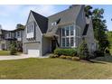 Stunning exterior of a two-story home with large windows, manicured lawn, and charming curb appeal at 3416 Edgemont Dr, Raleigh, NC 27612