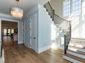 Elegant foyer with hardwood floors, staircase, and abundant natural light at 3416 Edgemont Dr, Raleigh, NC 27612