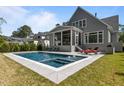 Relaxing pool area with patio, lounge chairs, and a screened-in porch for outdoor entertaining at 3416 Edgemont Dr, Raleigh, NC 27612