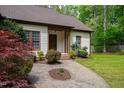 Inviting front entrance with a brick walkway and colorful landscaping around the home at 3428 Hardwood Dr, Apex, NC 27539