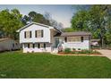 Charming two-story home with landscaped yard and blue front door at 3713 Arrowwood Dr, Raleigh, NC 27604