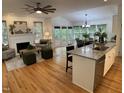 Open living space with fireplace, hardwood floors, and large windows, connecting to the dining and kitchen areas at 409 Parkside Cir, Chapel Hill, NC 27516