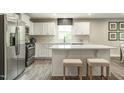Modern kitchen with stainless steel appliances, a center island with seating, and quartz countertops at 42 Saintsbury Dr, Fuquay Varina, NC 27526