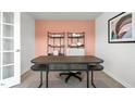 Well-lit home office space featuring neutral colors, modern desk, shelves and view of front yard at 487 Lochalsh Dr, Gibsonville, NC 27249