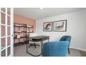 Bright home office featuring soft peach accent wall, neutral carpet and two blue chairs at 487 Lochalsh Dr, Gibsonville, NC 27249