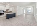 Open-concept living room and kitchen with hardwood floors, white walls, and abundant natural light at 512 Gainer Dr # 4, Raleigh, NC 27610