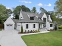 Beautiful home with a three-car garage, manicured lawn, and a welcoming front entrance at 5504 Kingwood Dr, Raleigh, NC 27609
