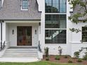 Close-up of the front entrance showcasing a stone staircase, wooden door, and elegant design at 5504 Kingwood Dr, Raleigh, NC 27609
