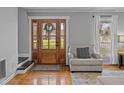Inviting foyer featuring hardwood floors, a wood door and a comfortable chair at 555 Canterwood Dr, Mebane, NC 27302