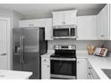 Well-equipped kitchen with stainless steel appliances and plenty of counter space for meal preparation at 57 South Breeze Way, Fuquay Varina, NC 27526