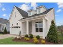 Side view of the home shows well-manicured landscaping and classic white brick exterior at 616 Gainer Dr # 15, Raleigh, NC 27610