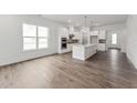 Bright kitchen featuring white cabinets, stainless steel appliances, kitchen island, and hardwood flooring at 616 Gainer Dr # 15, Raleigh, NC 27610