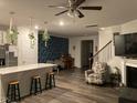Open living room featuring stylish decor, a fireplace, and a ceiling fan at 6332 Andante Ave, Raleigh, NC 27616
