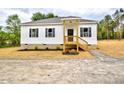 Charming single-story home with white siding, black shutters, and a cozy front porch at 68 S Grace Way, Henderson, NC 27537