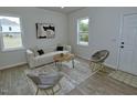 Inviting living room showcasing modern decor and ample natural light from two windows at 68 S Grace Way, Henderson, NC 27537