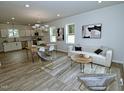 Bright, open-concept living room featuring modern decor, sleek flooring, and lots of natural light at 68 S Grace Way, Henderson, NC 27537