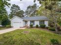 Charming single-story home with a well-maintained lawn and attached garage in a quiet neighborhood at 706 Mossburn Ct, Fuquay Varina, NC 27526