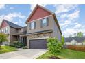 Charming two-story home with attached garage, stone details, and a well-maintained lawn and plantings at 8021 Crookneck Dr, Angier, NC 27501