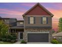 Charming two-story home with red and brown siding, stone accents, and attached two-car garage at 8021 Crookneck Dr, Angier, NC 27501