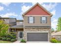 Charming two-story home with red and brown siding, stone accents, and attached two-car garage at 8021 Crookneck Dr, Angier, NC 27501