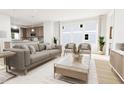 Open-concept living room with kitchen view, lots of natural light, and contemporary decor at 813 Fireship Rd, Fuquay Varina, NC 27526