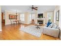 Cozy living room with a fireplace, hardwood floors, and natural light from windows with plantation shutters at 88 Eltham, Rocky Mount, NC 27804