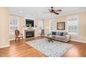 Inviting living room featuring a fireplace, hardwood floors, and a ceiling fan, creating a comfortable atmosphere at 88 Eltham, Rocky Mount, NC 27804
