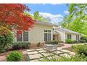 Attractive exterior with well-maintained patio and lush greenery at 919 Woodham, Pittsboro, NC 27312