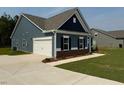 View of blue home with a two-car garage and concrete driveway at 95 Knoll Way, Sanford, NC 27332