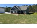 A charming blue home with lush green lawn, situated in a peaceful neighborhood at 95 Knoll Way, Sanford, NC 27332