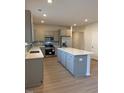 Modern kitchen with stainless steel appliances, a central island, and ample cabinet storage at 95 Knoll Way, Sanford, NC 27332