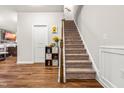Inviting stairway with carpeted steps, wooden handrail, and decorative accents at 1018 Sweet Cream Ct, Durham, NC 27703